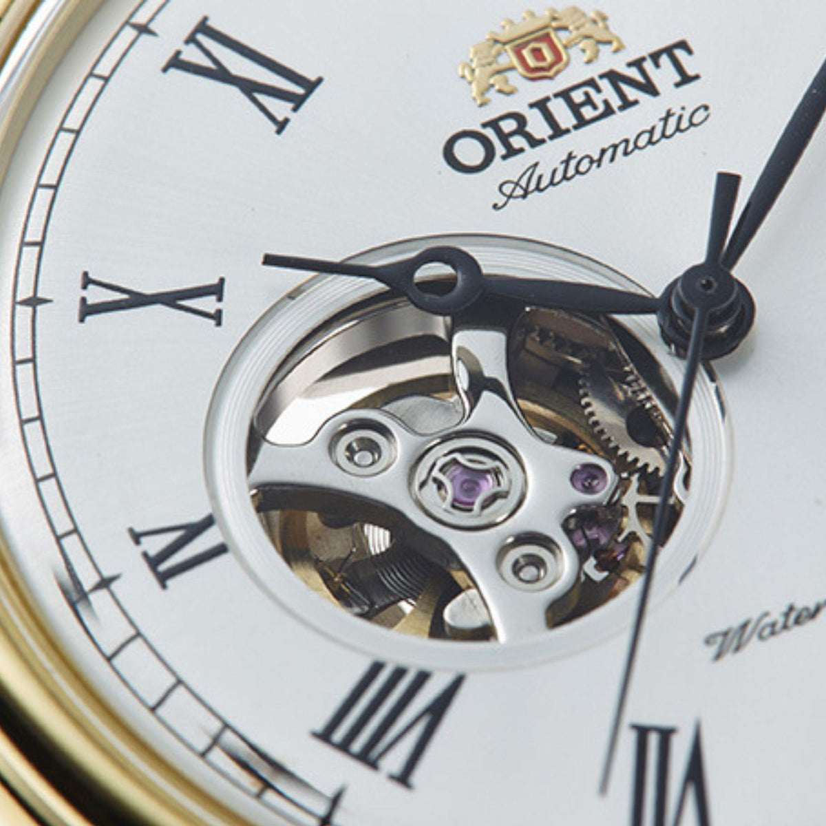 Open-heart automatic watch dial showing mechanical movement, Roman numerals and black hands