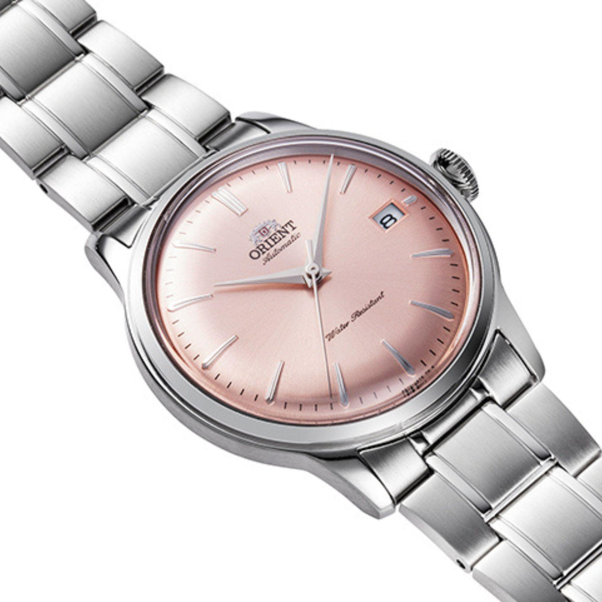 Close-up angle of Orient Bambino RA-AC0M11Y30B wrist watch displaying curved crystal glass and pink face
