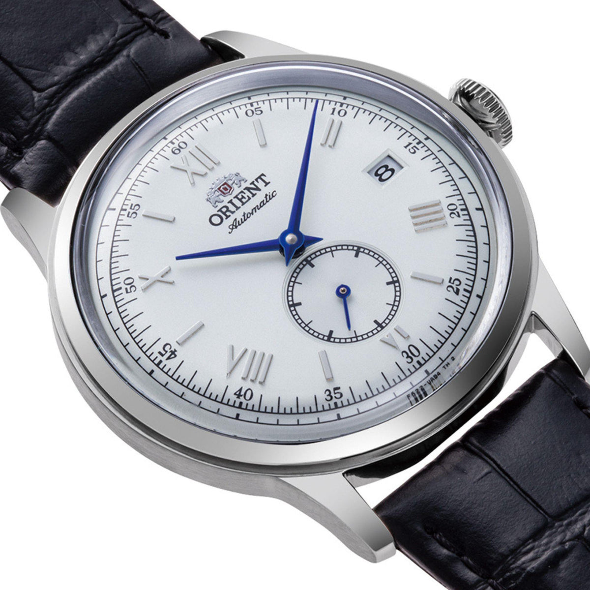 Men's automatic watch close-up: white dial, blue hands, date window, black leather strap