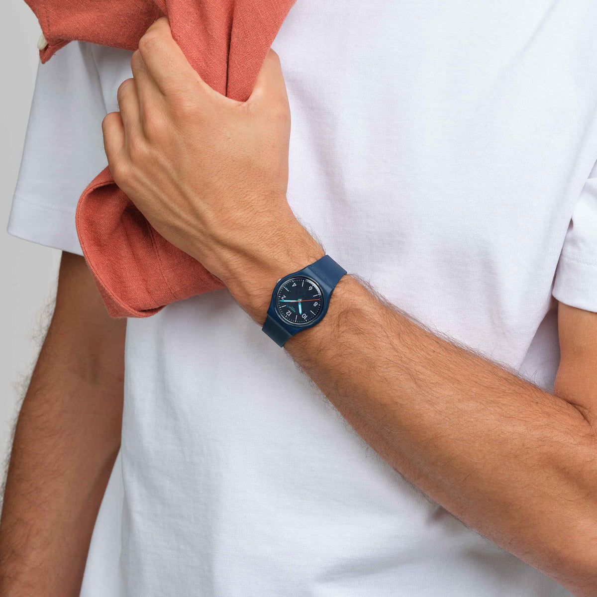 Biosourced quartz watch on wrist, dark blue dial, matching strap, orange-seconds hand