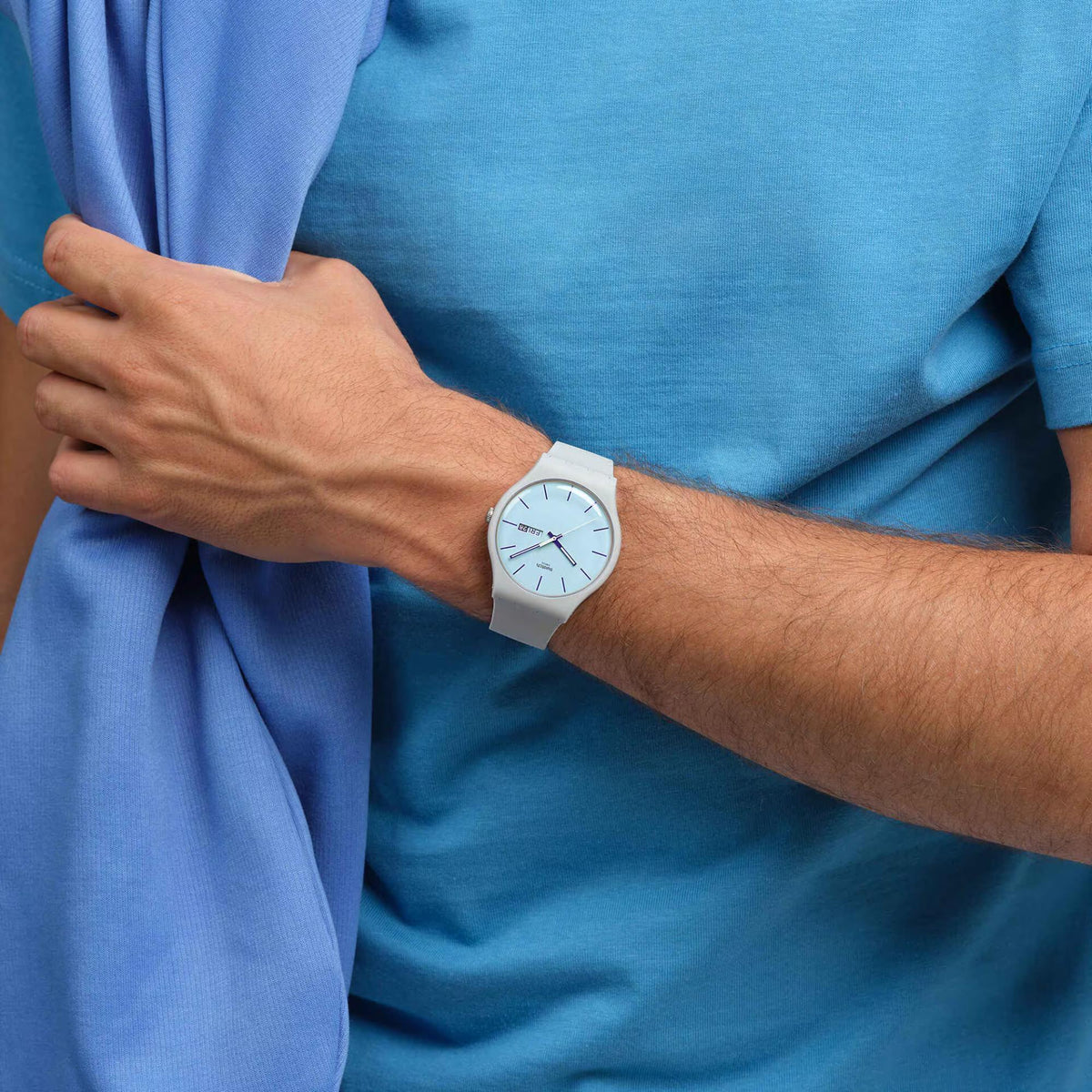 Wrist-worn blue dial quartz watch with gray silicone strap, analog hands and Fri 28
