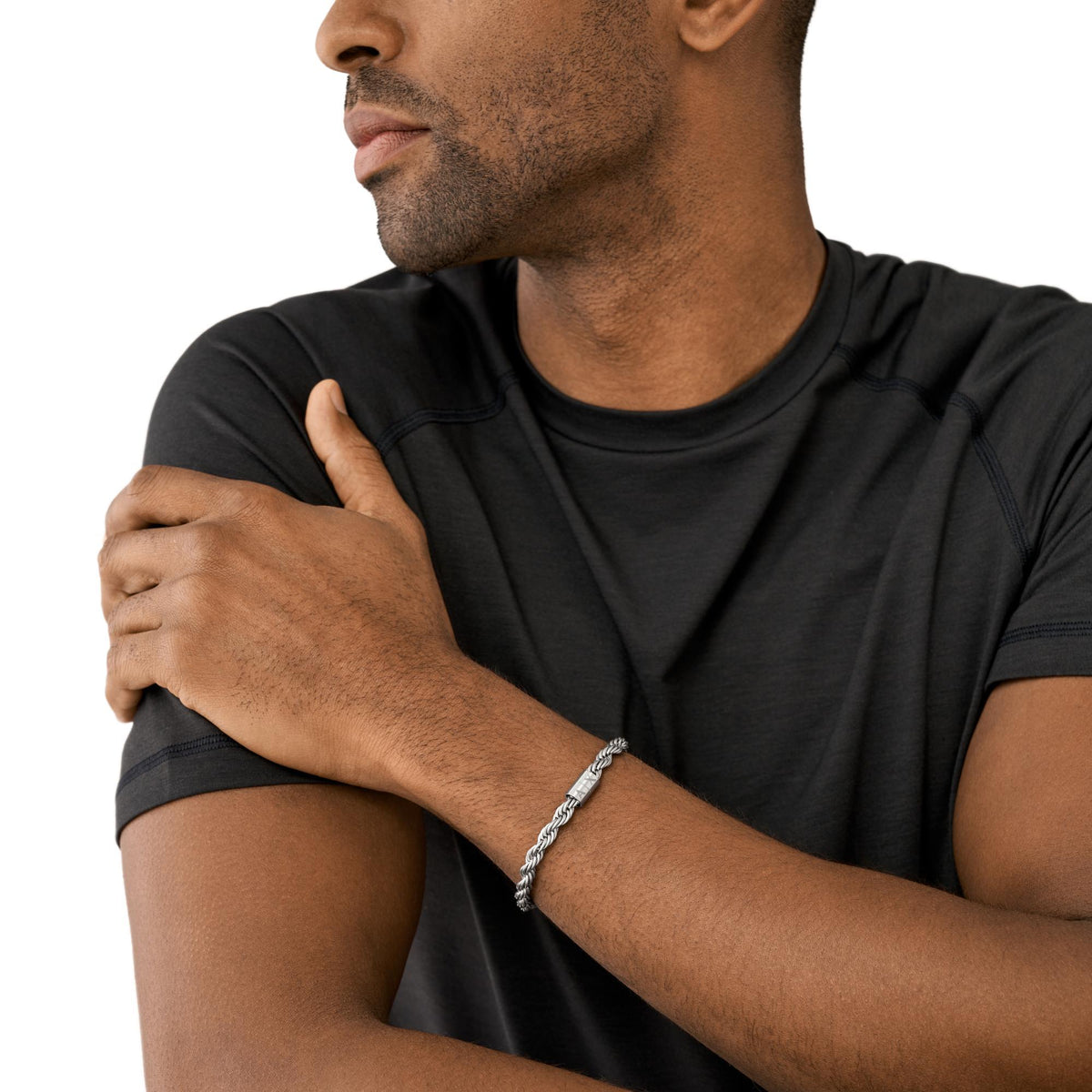 Men's stainless steel chain bracelet on wrist, toggle clasp and links visible