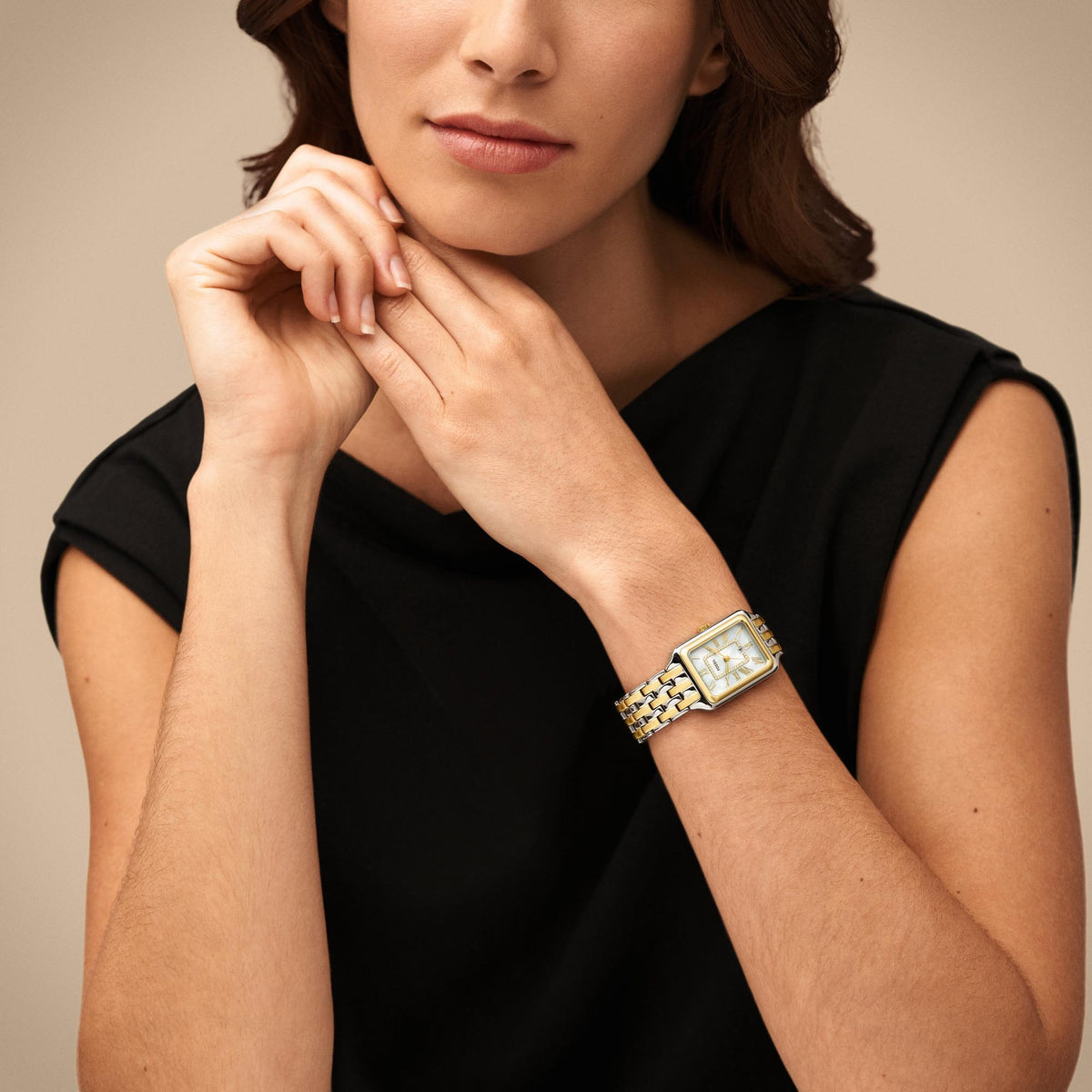 On-wrist lifestyle shot featuring the Fossil Raquel ES5305 ladies watch with its rectangular two-tone case and white dial display