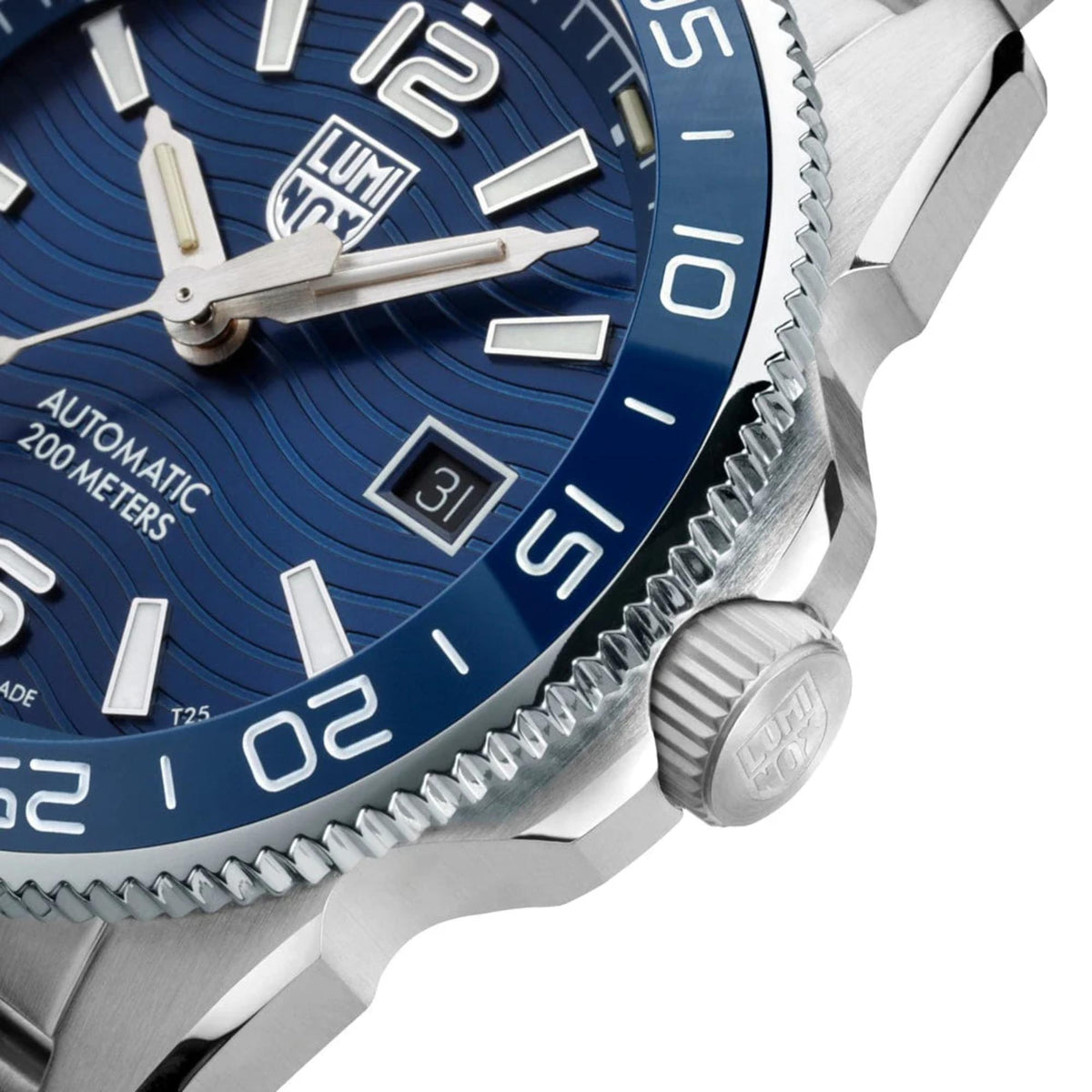 Close-up of blue dial and ridged bezel on stainless steel diver watch with date window