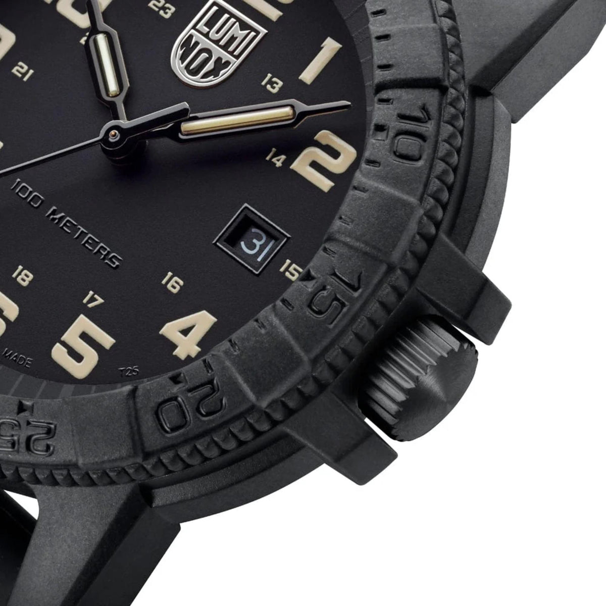 Close-up of black dial with gold-tone hands and date window, black rubber case