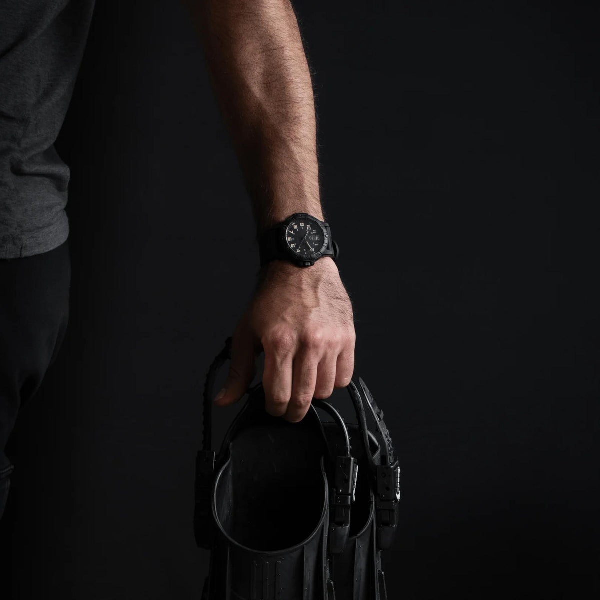 Black Luminox rubber quartz watch on wrist, round bezel with minute markers