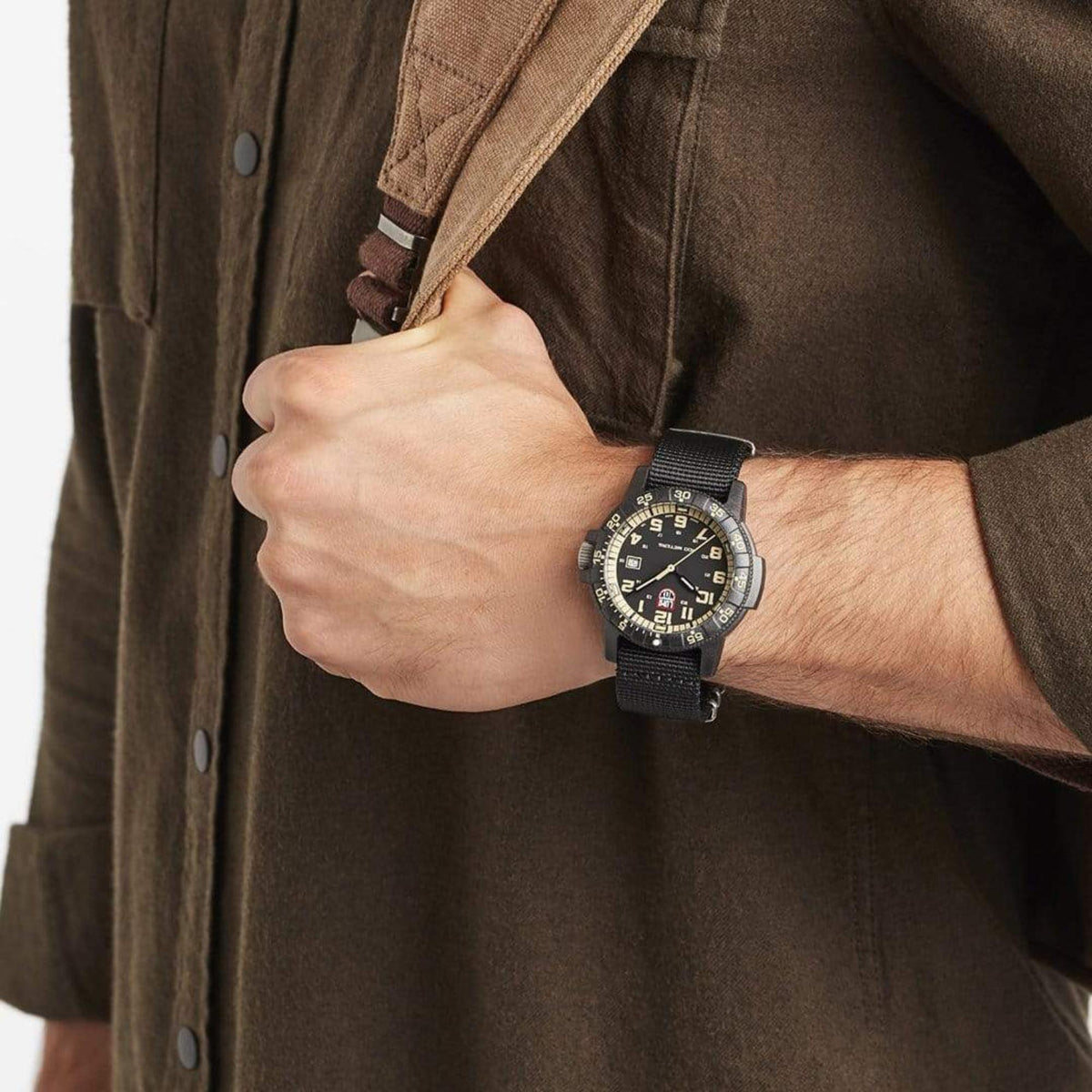 On-wrist lifestyle view of a man wearing the Luminox Leatherback Sea Turtle XS.0333 military-style watch with an olive shirt