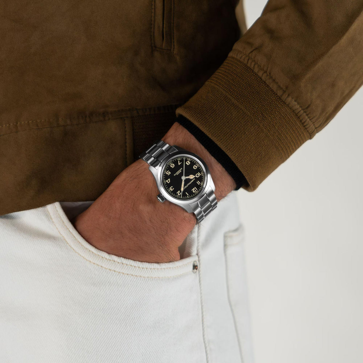 Hamilton Khaki Field Murph H70405130 mens automatic watch lifestyle wrist shot paired with brown jacket showing black dial