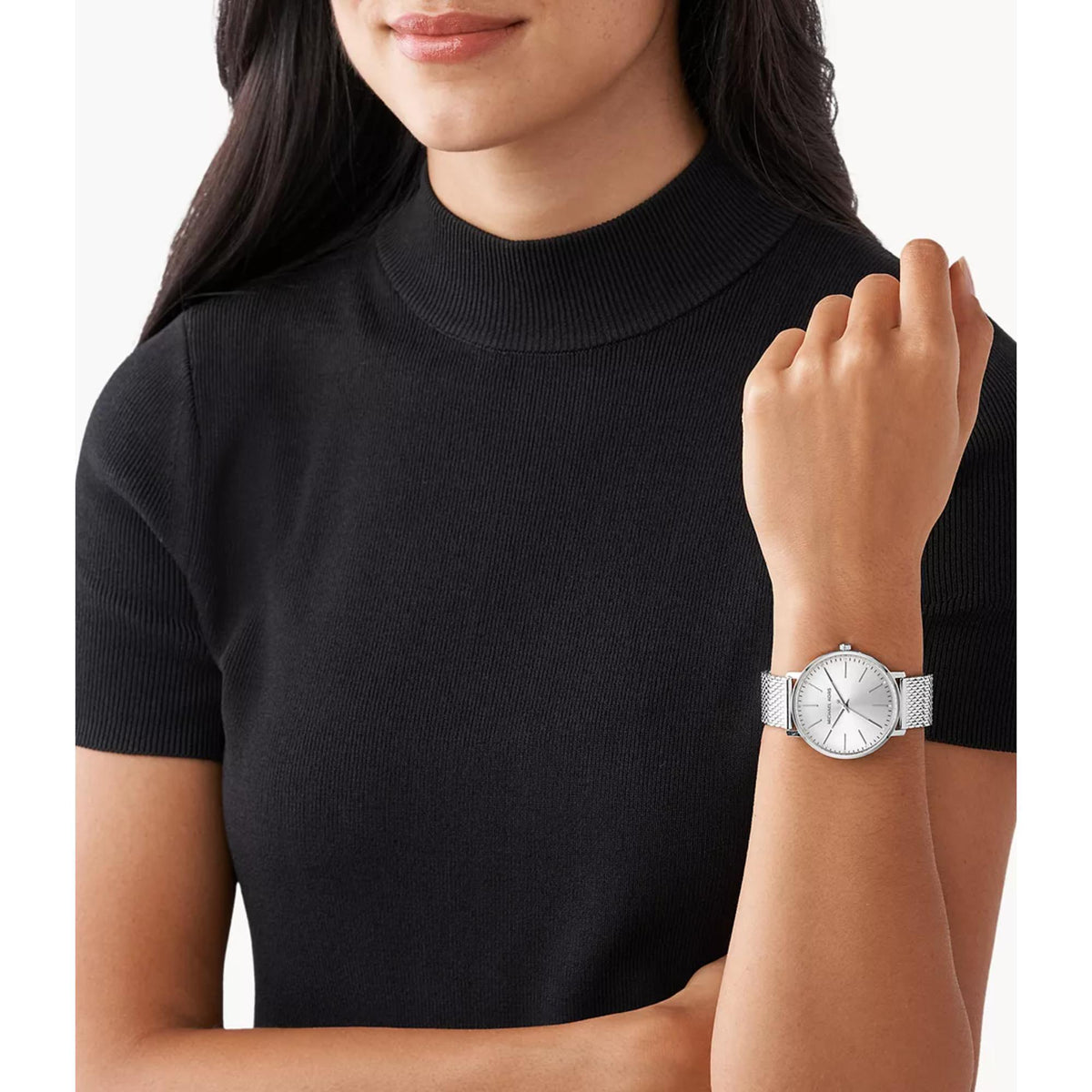 Silver dial stainless steel women's watch worn on wrist with link mesh bracelet