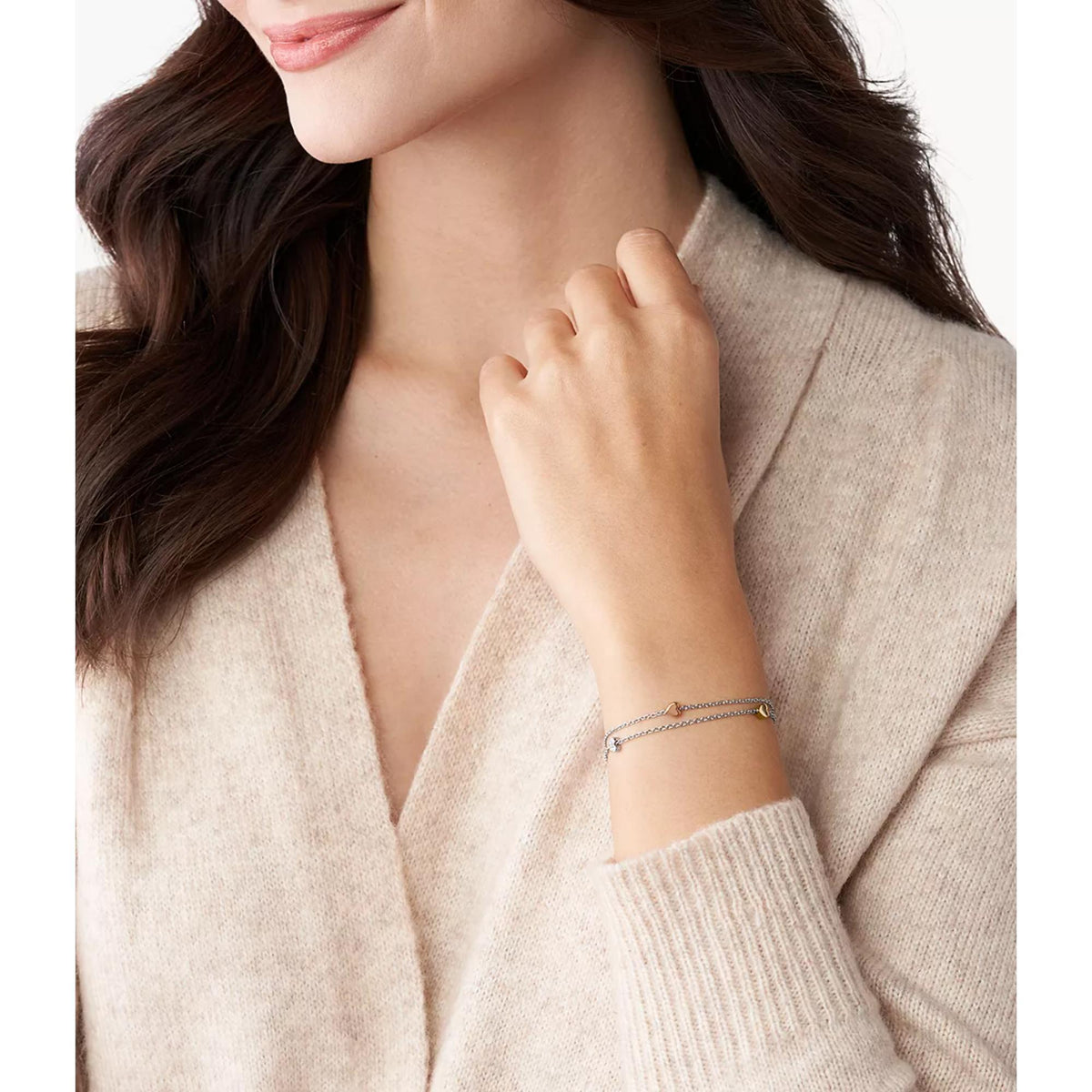Tri-tone heart bracelet with small chain links and charm, worn on wrist
