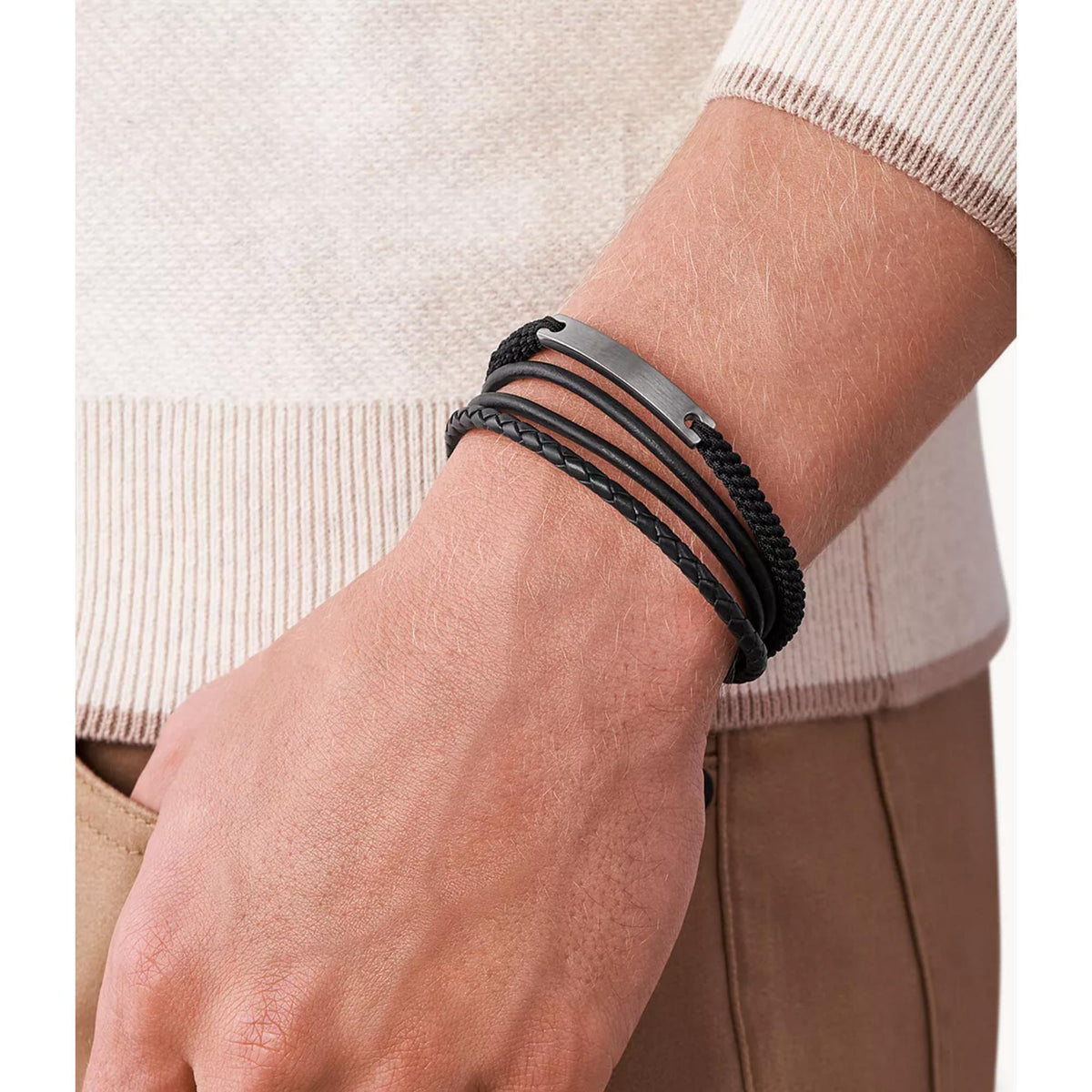 Men's black braided bracelet on wrist with layered straps and silver-tone clasp