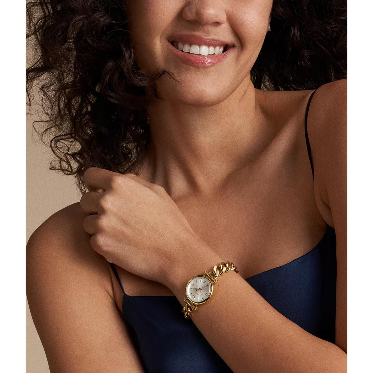 Fossil Carlie ES5329 28mm timepiece worn on a wrist, featuring a silver dial and gold-tone chain bracelet design