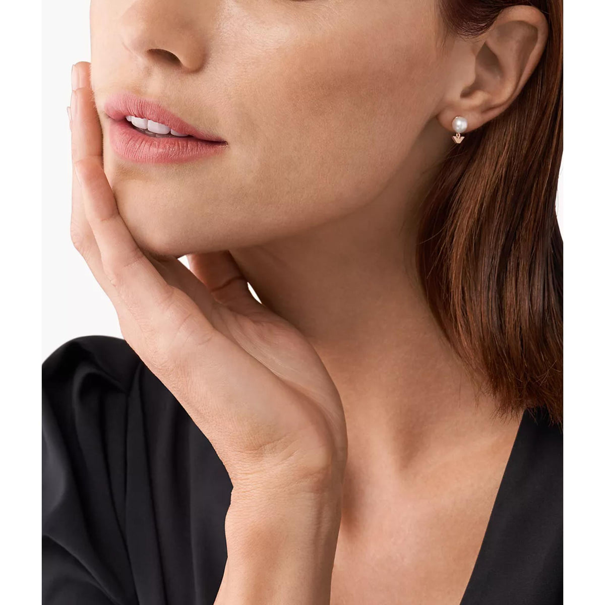 White pearl stud earrings on model with rose-gold geometric charm