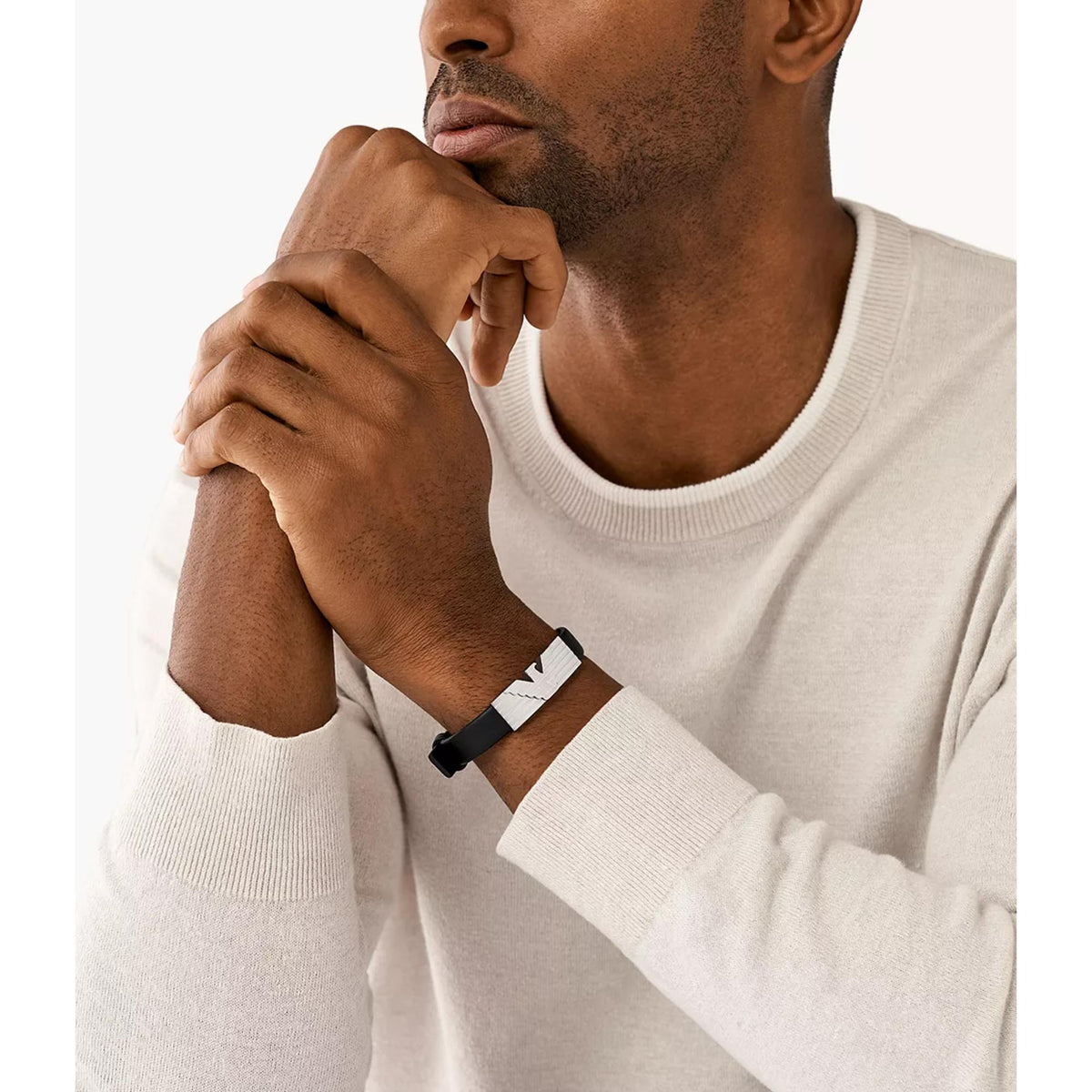 Black leather ID bracelet with stainless steel plate worn on a man’s wrist