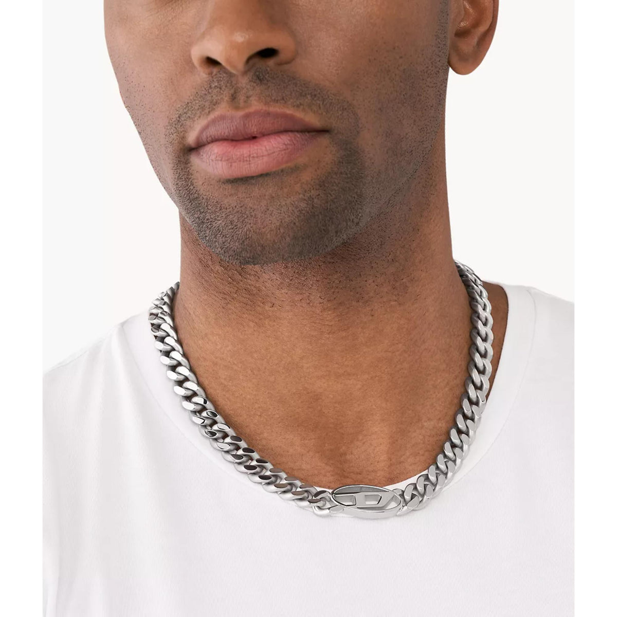 Stainless steel curb-link choker necklace with oval D logo, worn on neck