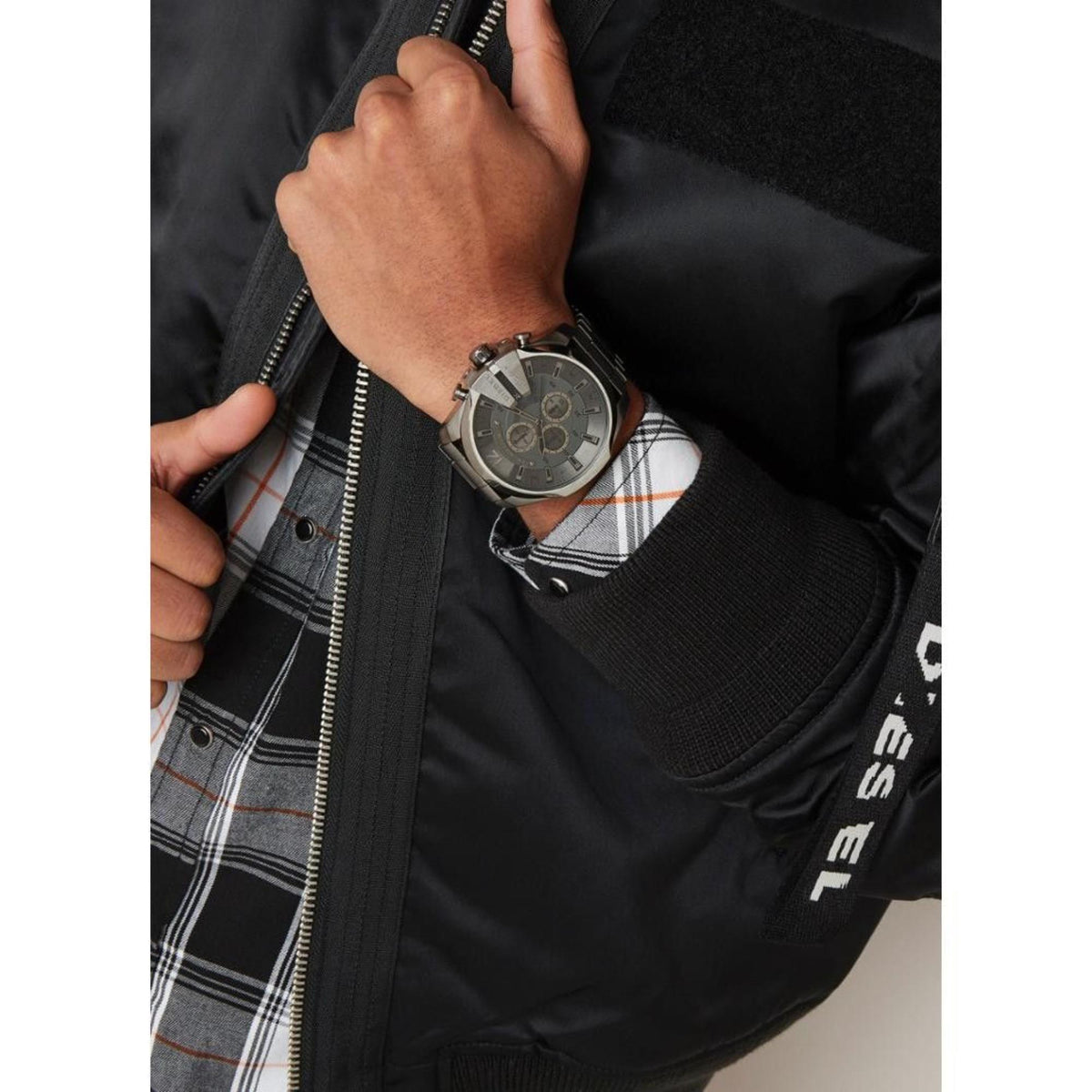 Diesel chronograph watch on wrist with dark grey dial and steel bracelet, quartz