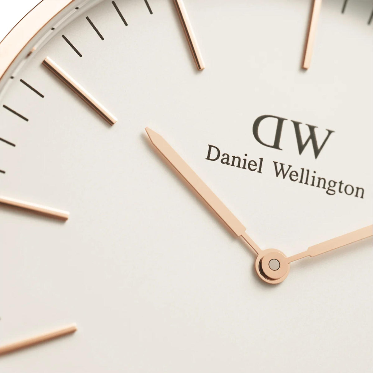 White dial wristwatch with rose gold hands and DW logo, brown leather strap