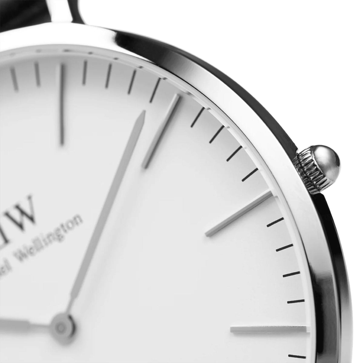 Round watch face close-up with white dial, silver hands and black minute markers