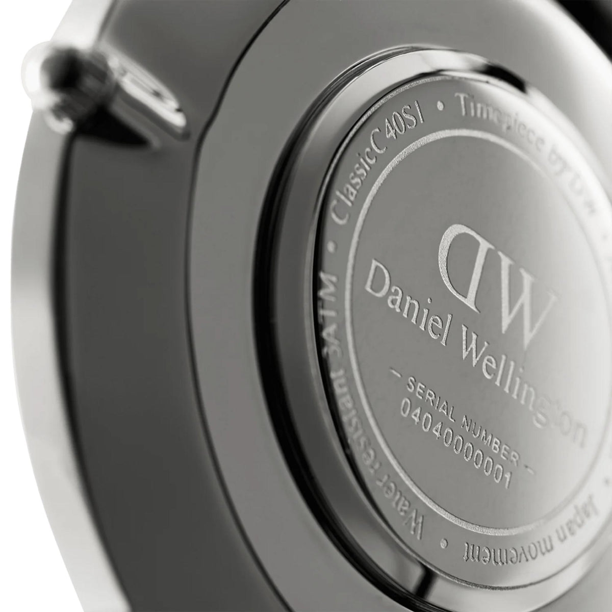 Engraved watch caseback with DW logo and Daniel Wellington text, silver finish