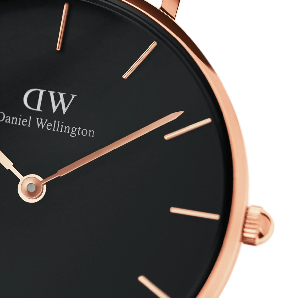 Close-up of rose-gold watch face with black dial, stick indices, and minute hand