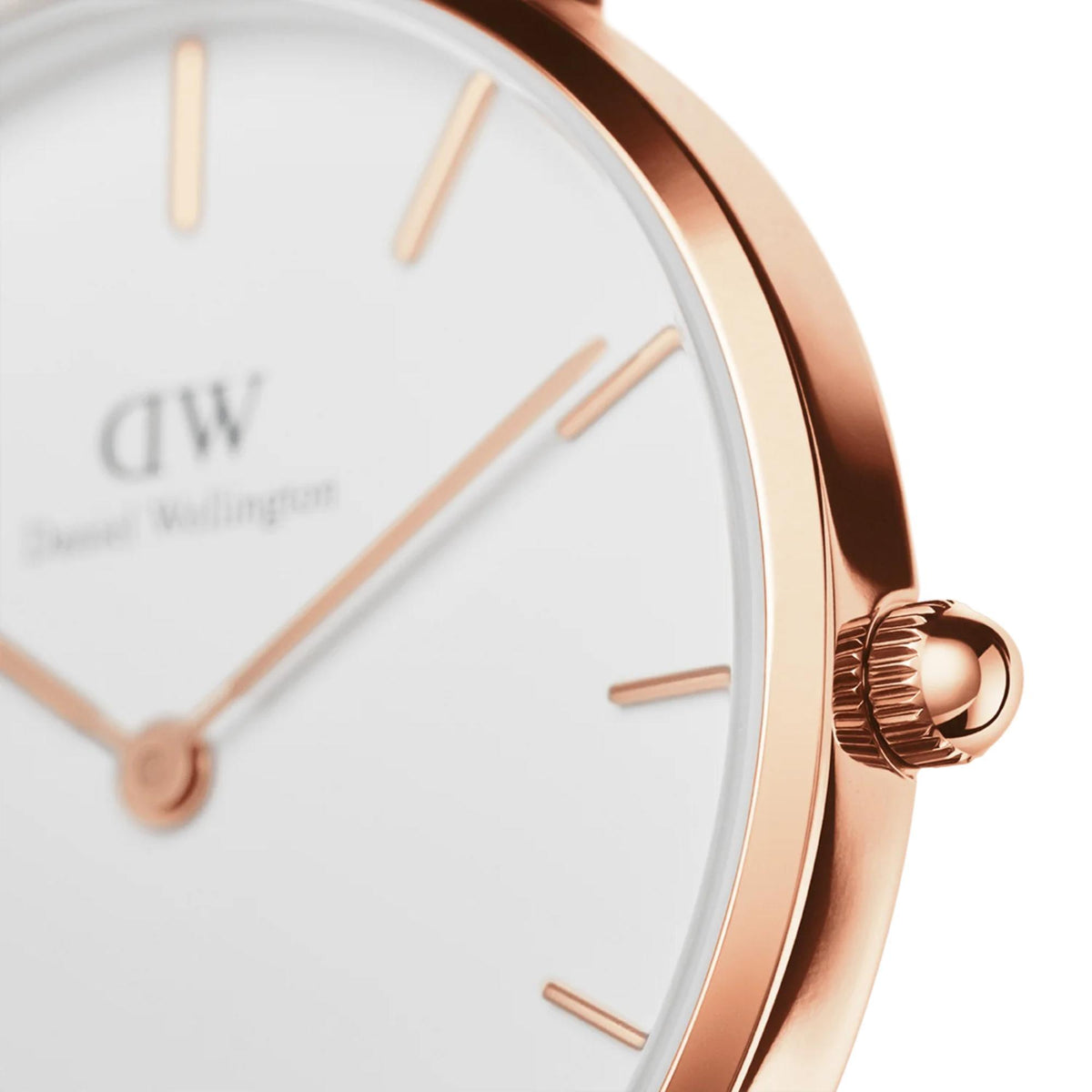 Close-up of rose-gold watch case and white dial with gold hands
