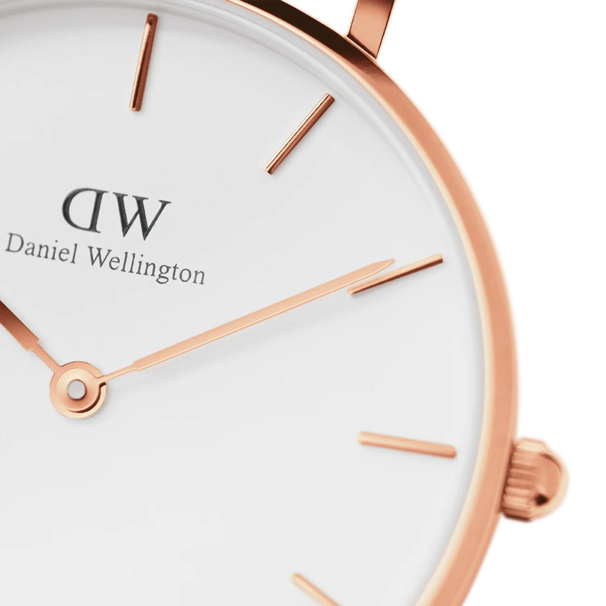 Close-up of white dial with rose-gold hour markers, hands, and DW logo