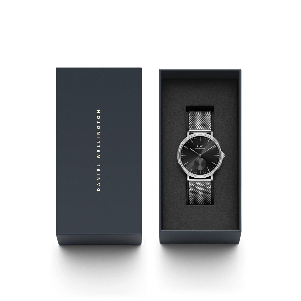 Daniel Wellington watch displayed in open presentation box with mesh steel bracelet.