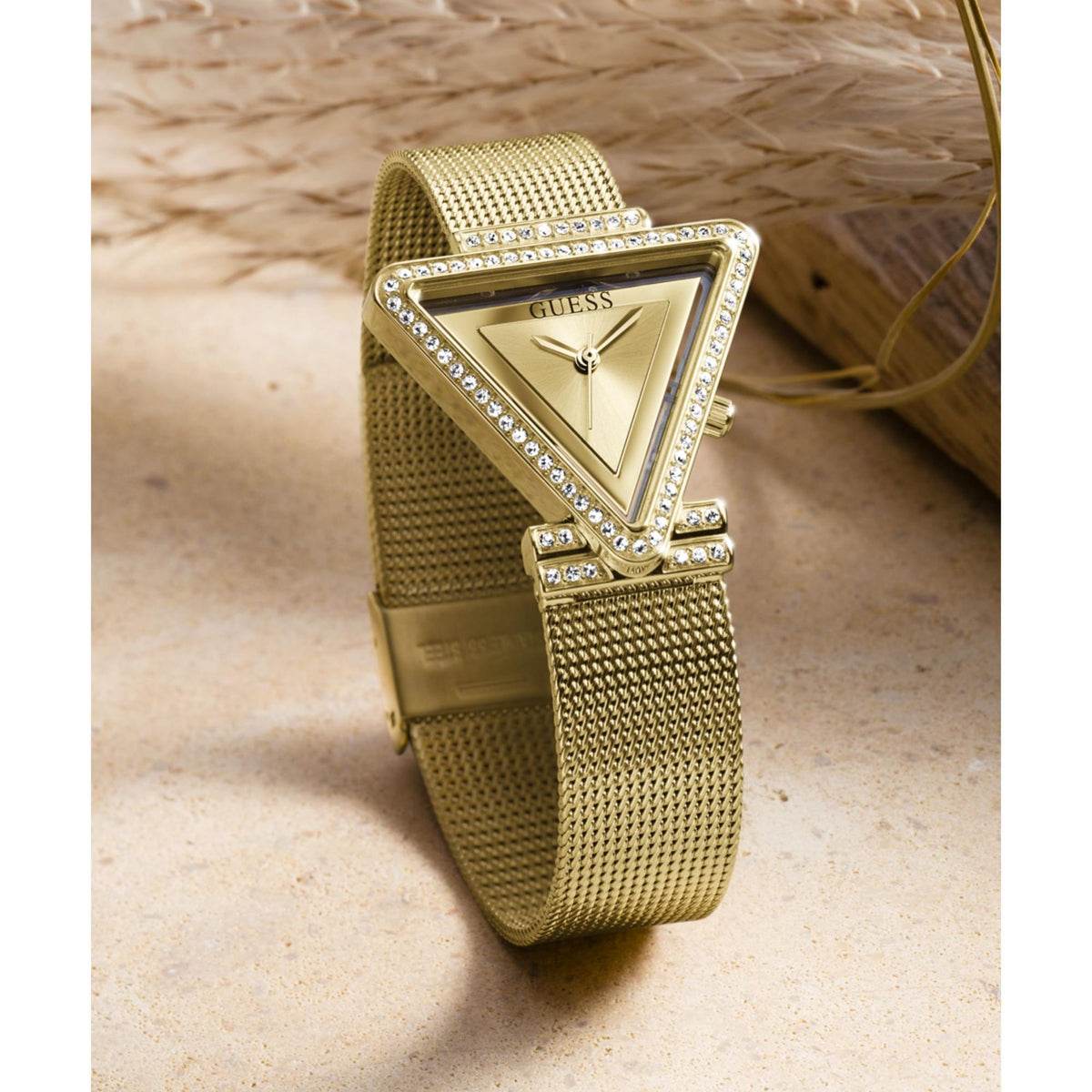 Gold tone analog watch with champagne dial, triangular crystal bezel, mesh band