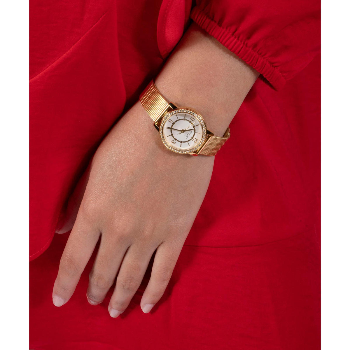 Womens analog watch on wrist, gold mesh bracelet, white dial with crystal bezel