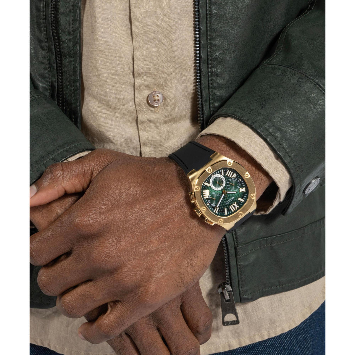 Men’s wrist watch with green dial, gold-tone case, and black silicone strap