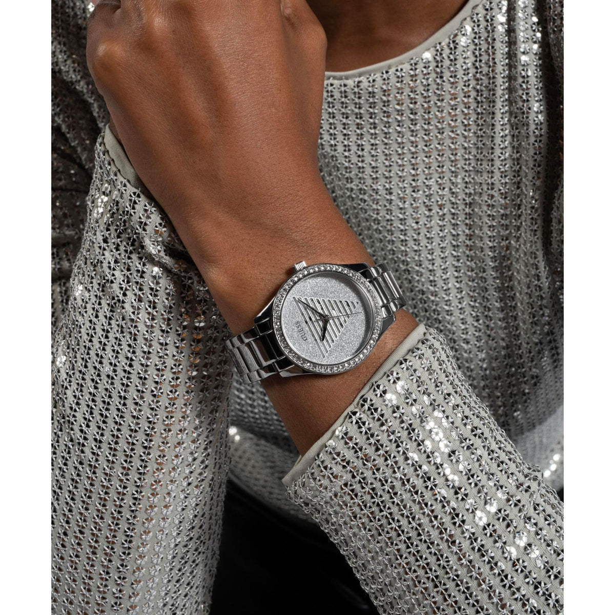 Silver-tone analog watch on wrist with stainless steel bracelet and sparkling bezel