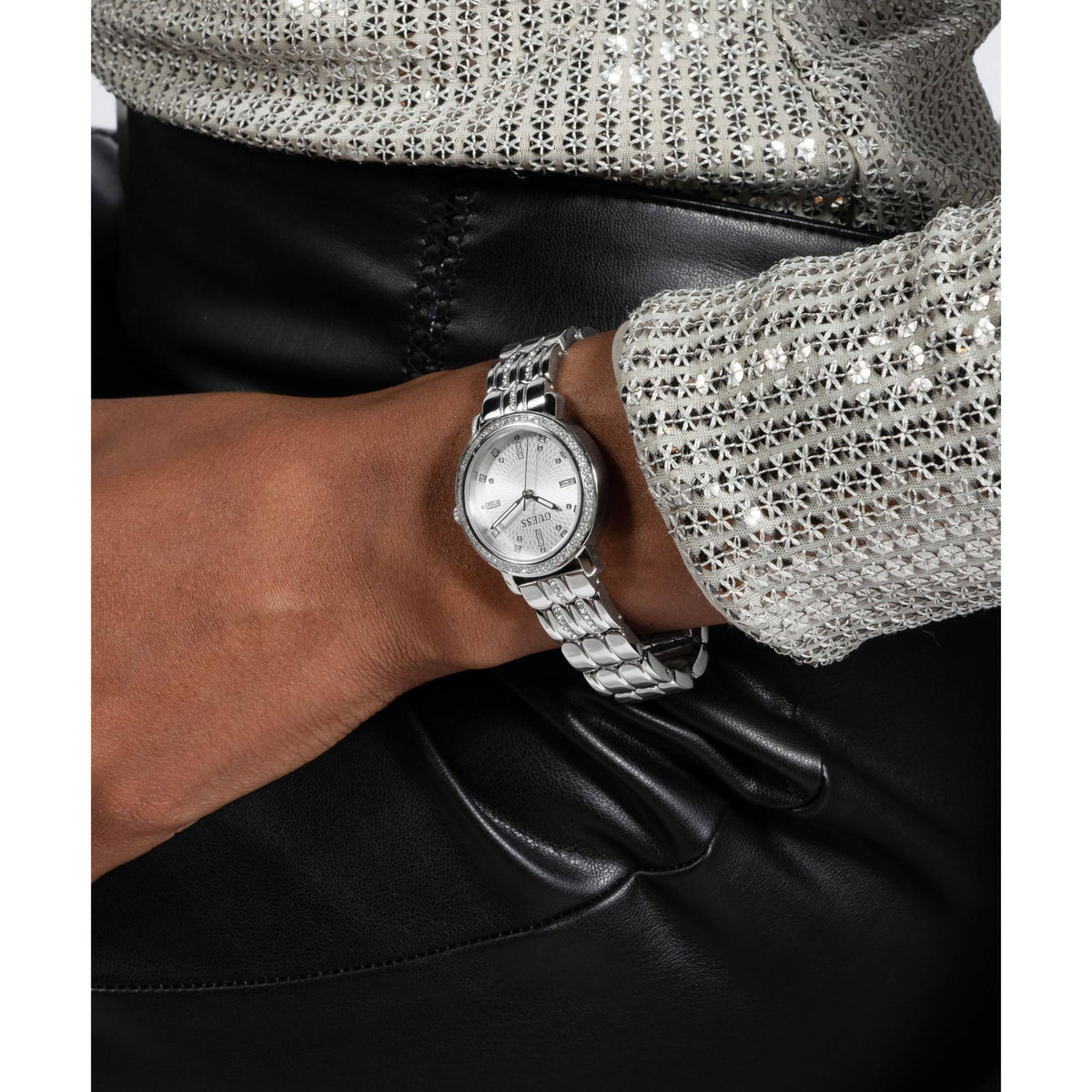Silver ladies watch on wrist with crystal bezel and rounded linked bracelet