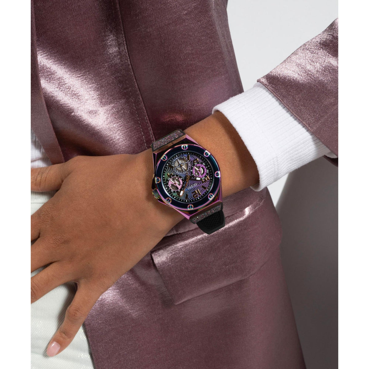 Iridescent wristwatch with black glitter strap on woman’s wrist