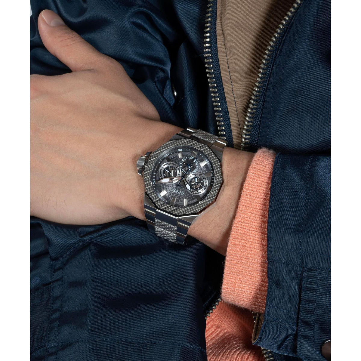 Men's octagonal watch on wrist showing grey dial and multi-function subdials on steel bracelet