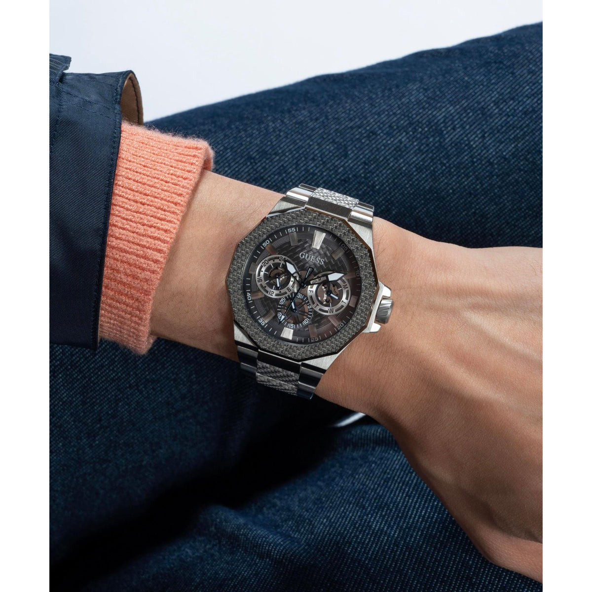 Men's grey dial watch worn on wrist, silver-tone steel bracelet and octagonal case