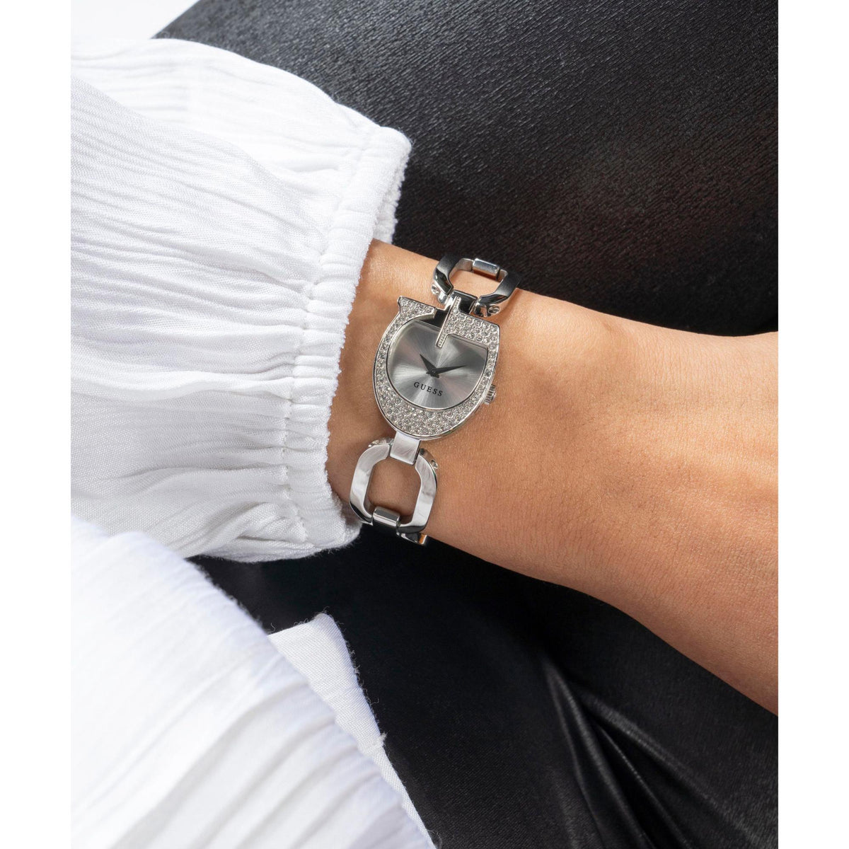 Silver analog ladies watch with crystal oval dial and silver link bracelet on wrist