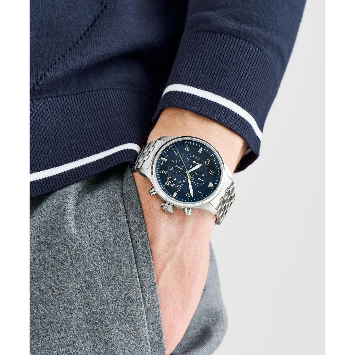 Men's wrist watch with dark blue dial and steel bracelet on a sleeve