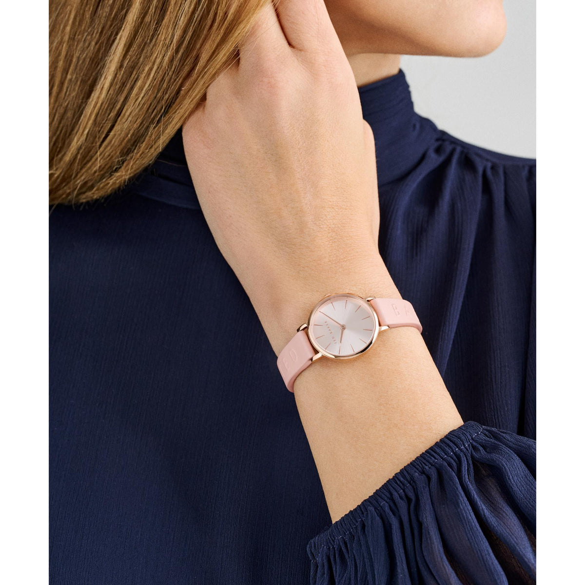 Ted Baker ladies leather strap watch on wrist, pale pink dial and pink leather band.