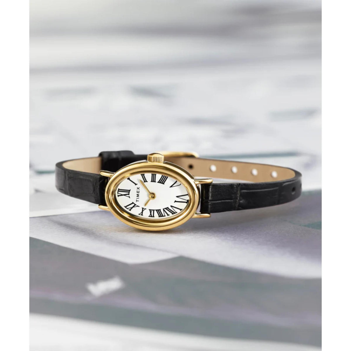 Black leather strap ladies watch with white dial and gold-tone round bezel