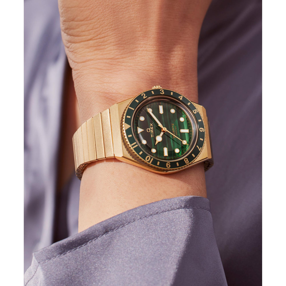 Green dial gold-tone steel ladies quartz watch with round case and bracelet