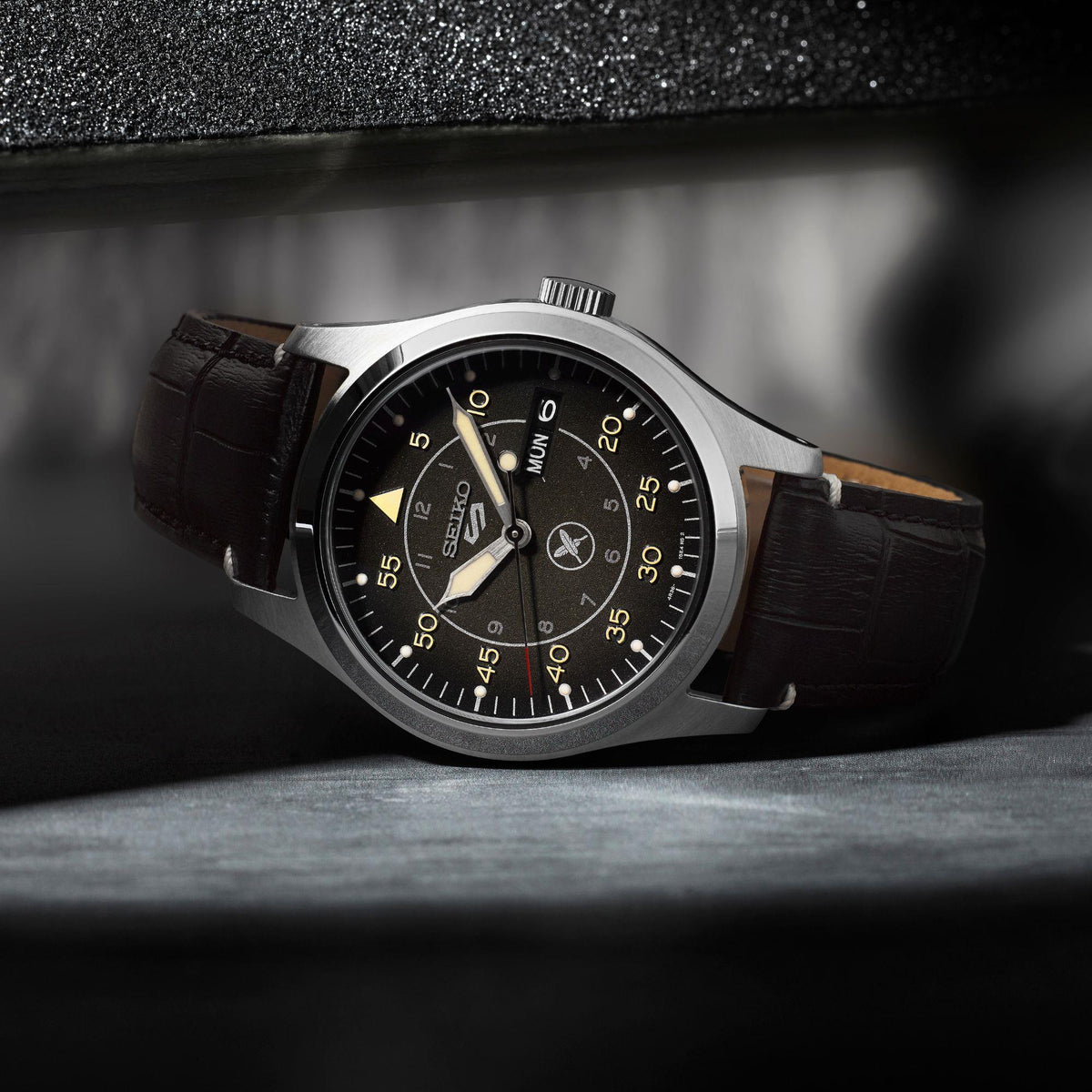 Seiko 5 Sports SRPL31K1 rest view on dark textured surface