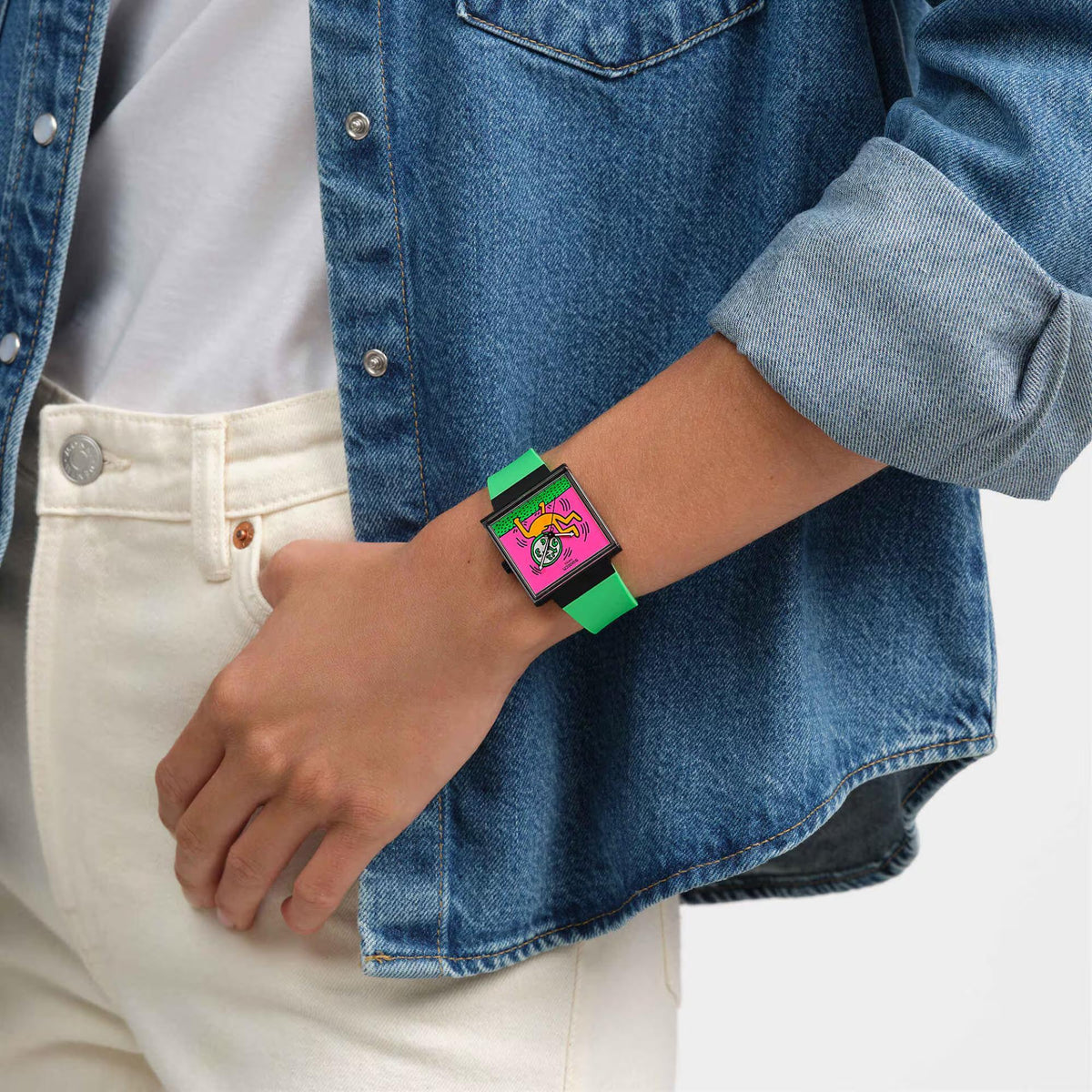 Women’s watch close-up on wrist: green silicone strap, square black case, pink dial