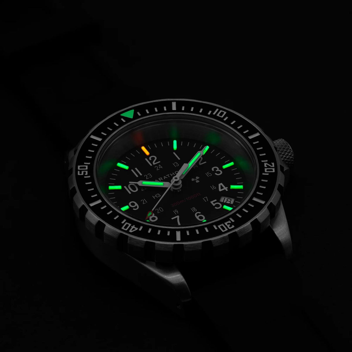 Men’s diver watch with glowing green lume hands and markers on black dial.
