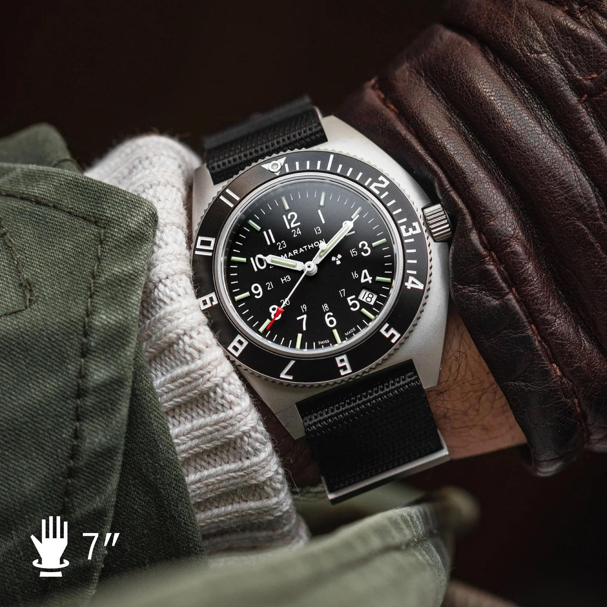 Men's steel watch with black dial, black fabric strap, and luminous hands