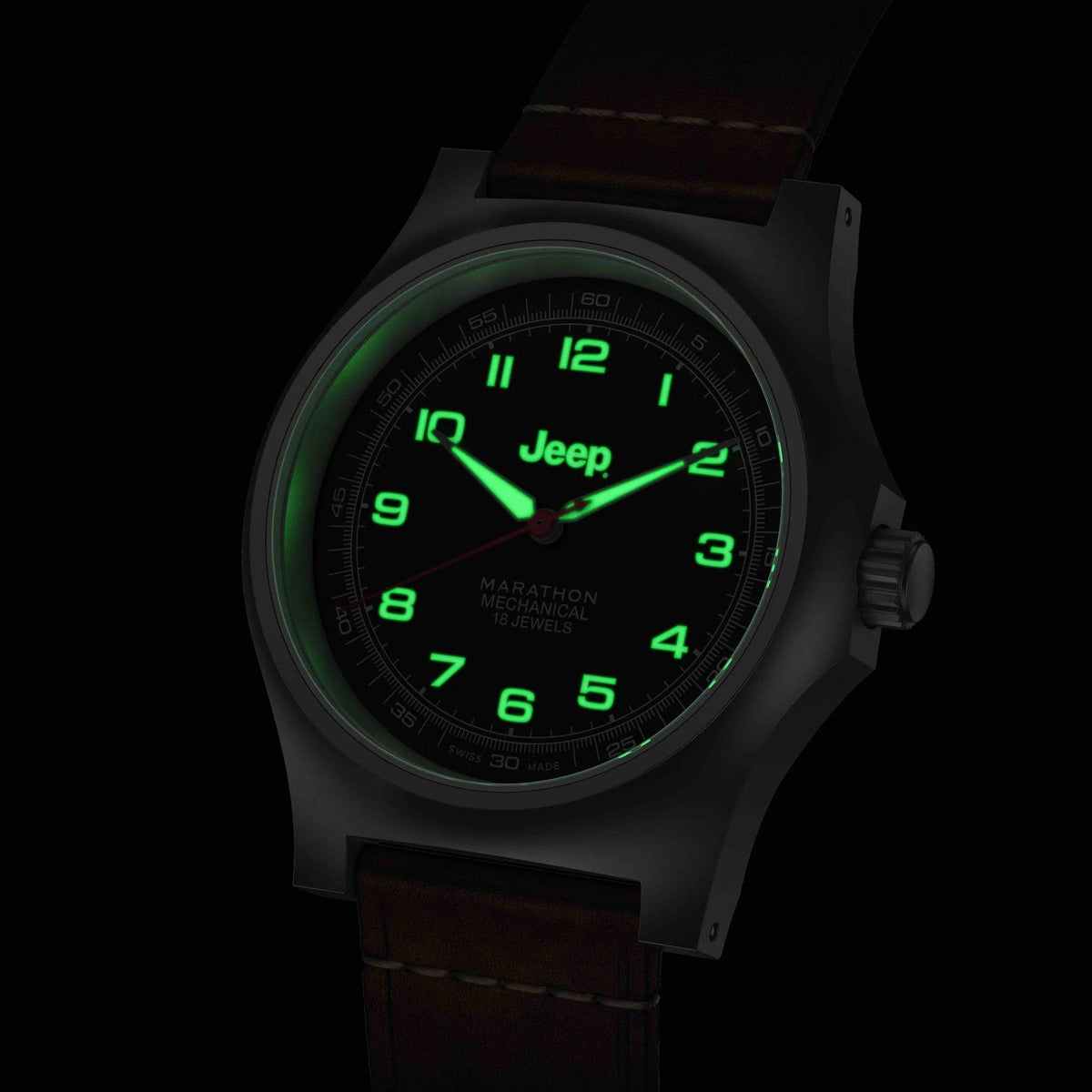 Men's mechanical watch with black dial showing green luminous markers and brown leather strap