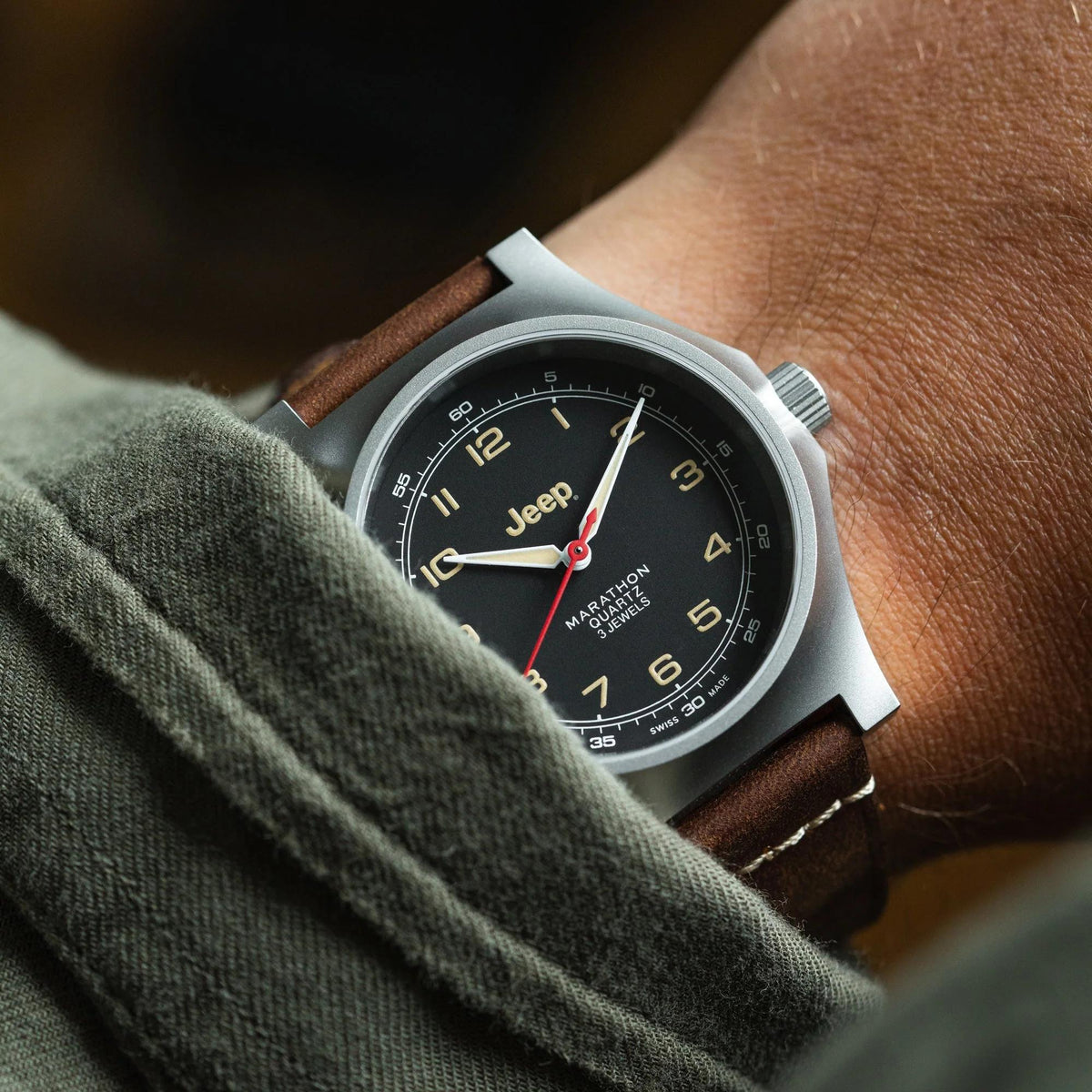 Men's stainless steel watch with black dial, brown leather strap, and quartz hands.