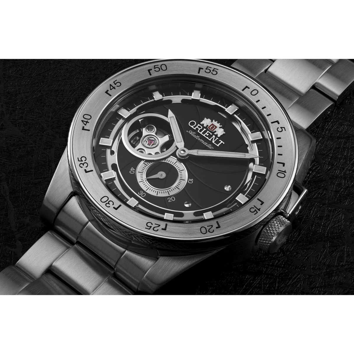 Men's steel automatic watch close-up: black dial with exposed mechanism and bezel markers
