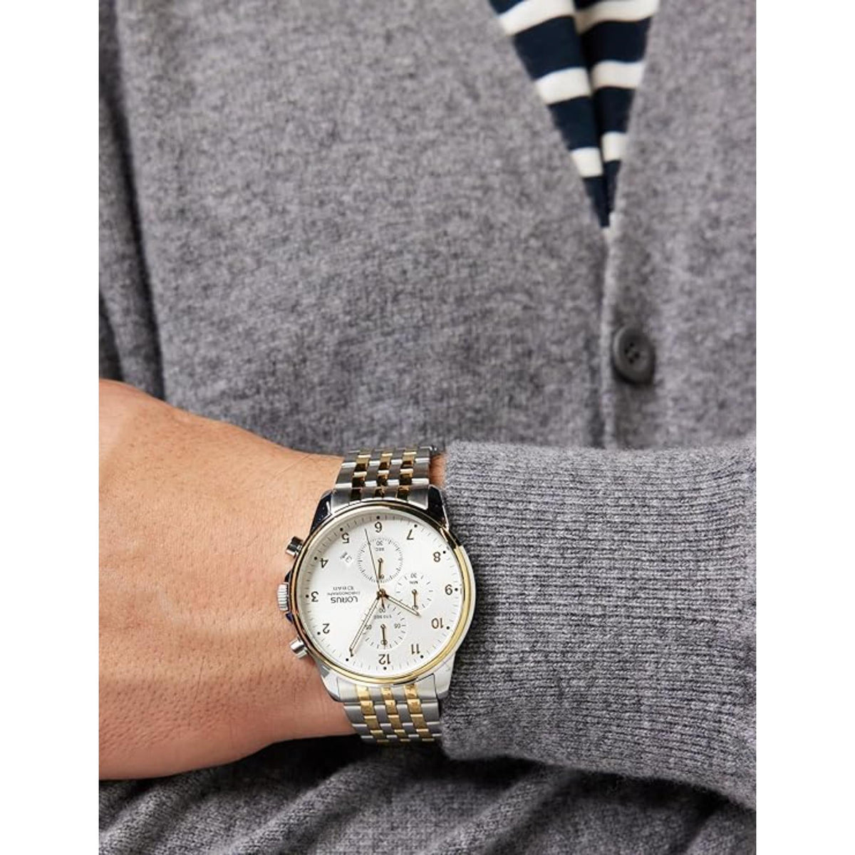 Men's two-tone chronograph watch on wrist with white dial and gold-accent bracelet