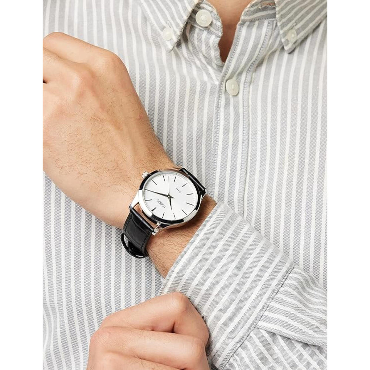 Lorus men's wrist watch with black leather strap and white dial, worn with striped shirt