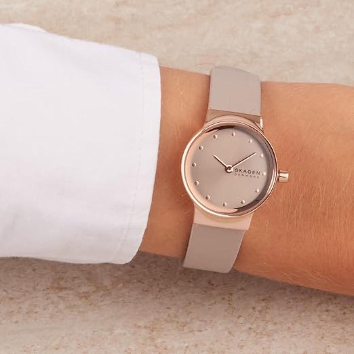 Close-up shot of the Skagen Freja Lille SKW3005 timepiece with a greystone dial against a white cuff